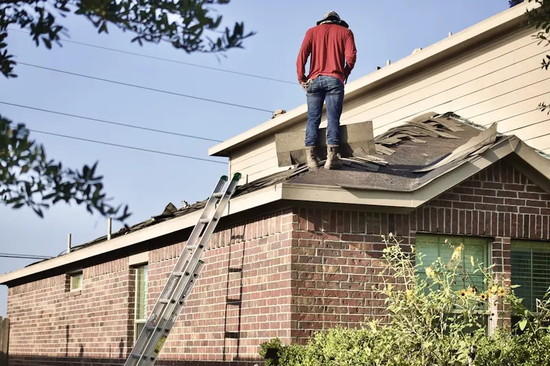 Professional roofer working on a residential roof in Deleon Springs